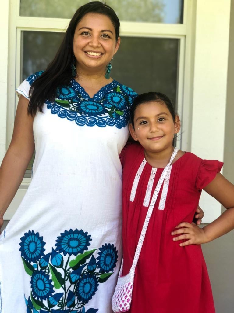 Chef Maggie in a traditional embroidered Mexican dress with her daughter